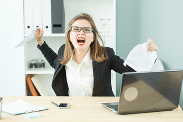 Stress, office, hysteric, people concept - aggressive woman with a lot of work in office