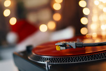 Image Of Christmas. Turntable Vinyl Record Player. Sound Technology For DJ To Mix & Play Music. Retro Audio Vinyl Record On A Background Of Christmas Decorations
