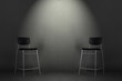 © Dmitriy - Two black chairs isolated on gray background in the studio with copy space. Job interview room.