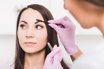 Sticker - Beautiful young woman gets eyebrow correction procedure