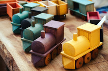 Many Wooden Train Toys On A Wood Table