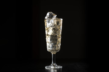 Wall Mural - dark background whiskey ice glass ice hand photo moody pouring alcohol bourbon bartender bar hotel home