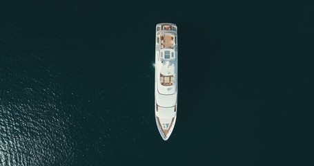 Wall Mural - Top-down aerial view of large white yacht, camera movement up