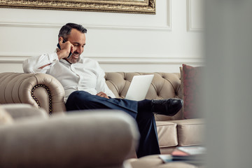 CEO on business trip working from hotel room