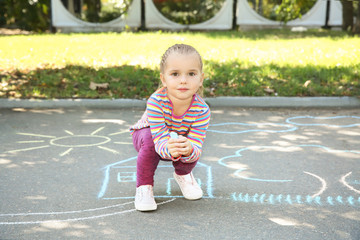 Canvas Print - Little child drawing with colorful chalk on asphalt