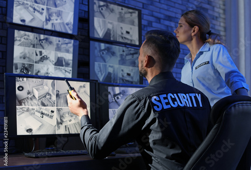 Fotografía Security guards monitoring modern CCTV cameras indoors