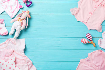 Wall Mural - flat lay composition with stylish baby clothes and toys on wooden background. space for text