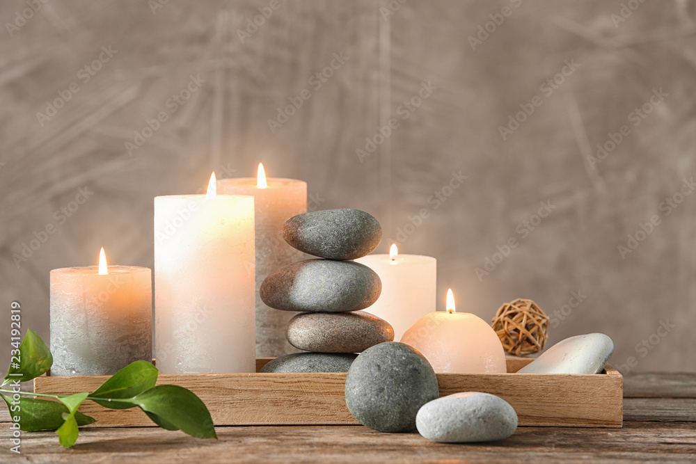 Composition with spa stones on wooden table - obrazy, fototapety, plakaty 