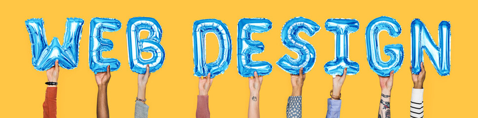Hands holding web design word in balloon letters