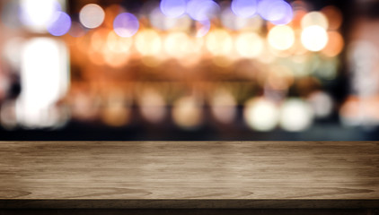 Fototapete - Wood table top with blur nightclub bar counter with bokeh light background,banner mock up for display of product or design content.