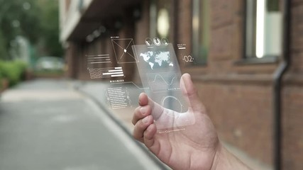 Future is now. Man using smartphone with futuristic touch screen. Closeup of a male's hand holding a mobile telephone. Concept of the near future and technologies. White screen backlight