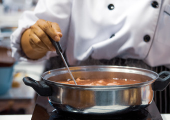 Wall Mural - Chef preparing food, meal, in the kitchen, chef cooking, Chef decorating dish, closeup, .Chef preparing food, meal, in the kitchen, chef cooking, Chef decorating dish, closeup, .