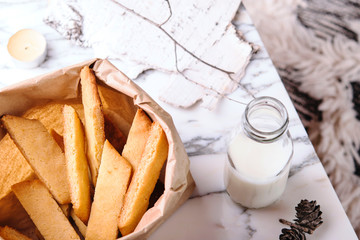 Wall Mural - Kolakakor - swedish cookies, bottle of milk and candle and pine cone on grey marble table. Fast and easy scandinavian pastry. Cozy winter treat. Hygge. Fika