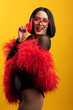 © Mat Hayward - Fun, colorful portrait of pretty Asian woman wearing red feather boa and heart shaped glasses
