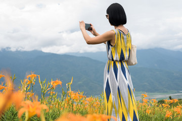 Wall Mural - woman taking a picture