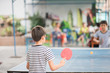 © wckiw - Kid playing table tennis outdoor with family