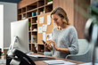© Rido - Business woman using smartphone while working