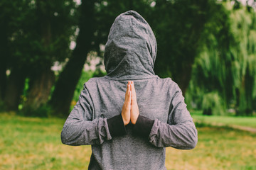 Wall Mural - upside down clothes hood with hidden person in pray pose 