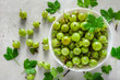 Green fresh gooseberry fruits in a bowl, top view