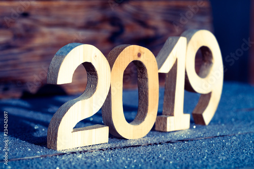 Fotografía Wooden number 2019 on wooden background. Happy new Year 2019.