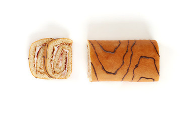 Wall Mural - Biscuit roll cut into pieces, on a white background.