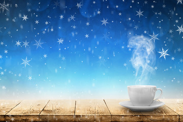 Wall Mural - hot coffee on the table on a winter background