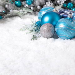 Christmas border with decoration and baubles on the snow square