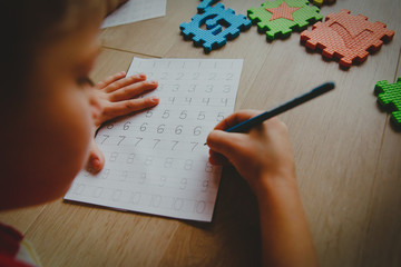 Wall Mural - little boy learning write and culculate numbers