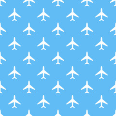 Wall Mural - Vector seamless pattern of white airplanes on blue background.