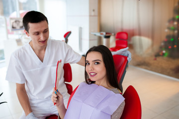 Wall Mural - The girl enjoys the excellent work of the dentist.