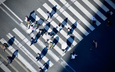 Topdown view of crossing lane with many people is crossing the road in the winter day time