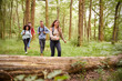 © Monkey Business - Multi ethnic group of four young adult friends walking in a forest during a hike, front view