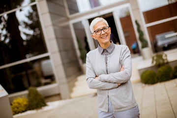 Wall Mural - Outdoor portrait of happy senior businesswoman