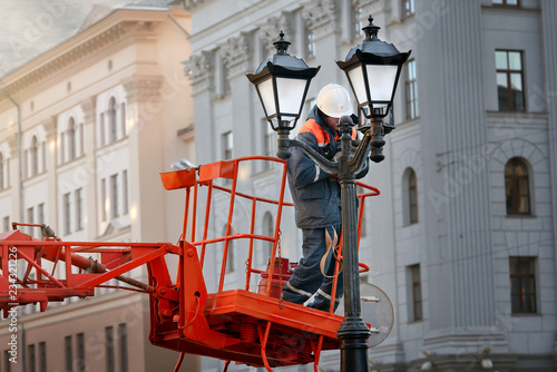 Worker During Work On Replacement Of Old Ceiling Light Cover