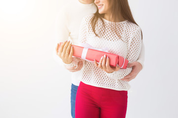 People, christmas, birthday, holidays and valentine's day concept - close up of man and woman with gift box on white background