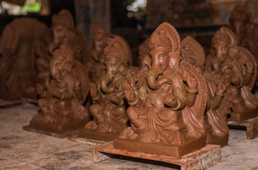 Wall Mural - Unfinished Clay model of Lord Ganesh\Ganesha being prepared by local artisans in India before the Hindu festival Ganesh Chaturthi 