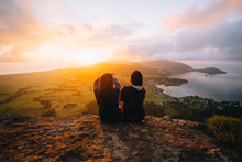 Two Women Looking At View At Sunset