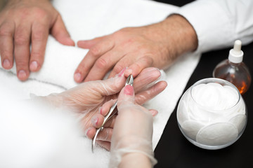 Close-up Of A Manicurist Cutting Off The Cuticle From The Person's Fingers