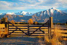 A Closed Wooden Farm Gate At The Entrance To A Farm In The High Country Below Snowy Mountains, Springfield, New Zealand	