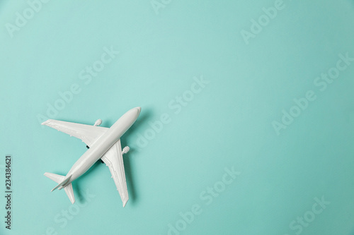 Fényképezés Simply flat lay design miniature toy model plane on blue pastel colorful paper trendy background