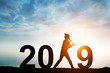 Silhouette of Softball Player in 2019 text for Happy New year Concept