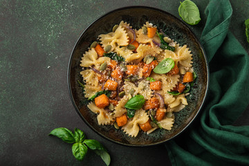 Wall Mural - pumpkin farfalle pasta with pumpkin seeds and cheese in bowl