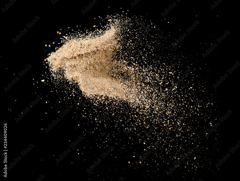 Sand flying explosion isolated on black background ,throwing freeze stop motion object design - obrazy, fototapety, plakaty 