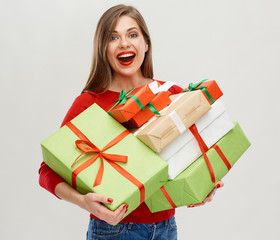 happy young woman holding pile of presents.