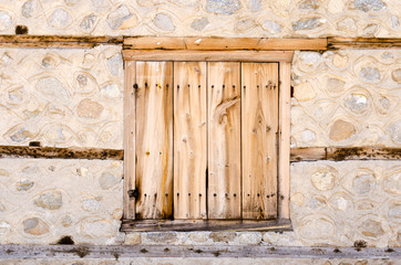 Old stone house wooden window