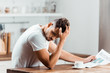 © LIGHTFIELD STUDIOS - upset young man reading newspaper in kitchen at morning