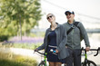 © Sergey - Image of happy man and woman with bicycles in park