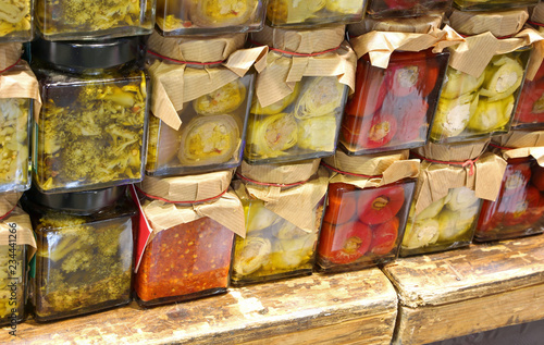Fotografía many glass jar in the italian store with broccoli in oil and mor