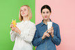 © master1305 - Diet. Dieting concept. Healthy useful food. Beautiful young women choosing between fruit orange juice and unhelathy carbonated sweet drink from fast food at studio. Human emotions and comparison