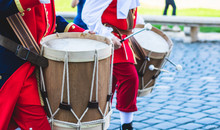 Member Of A Military Fanfare Playing A Mobile Bass Drum